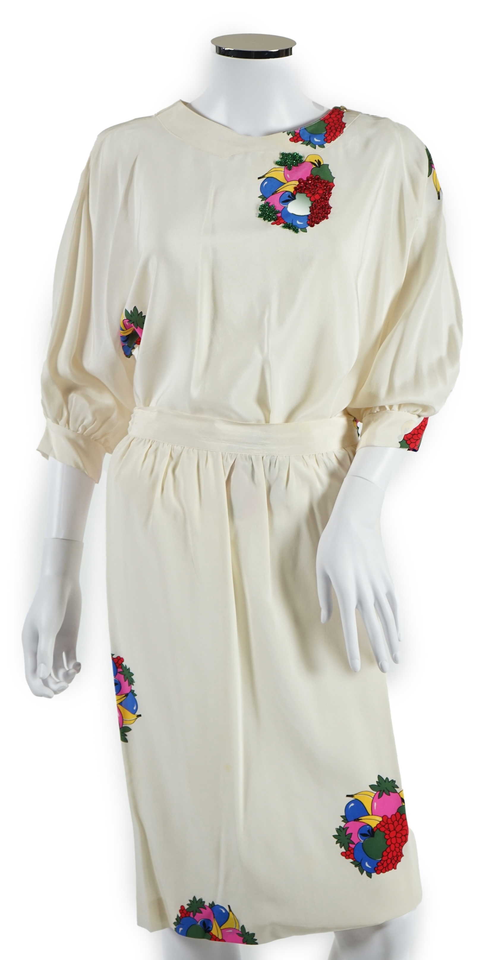 A lady's Angela Caputi silk cream skirt and blouse with fruit design size 46, a Ted Baker white lightweight cardigan with leaf design to the back size 4, a Rawhide dusky pink long laser cut coat size 14 and a Georgina vo